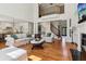 Sunlit living room featuring hardwood floors, tall windows and an open floorplan at 3115 Corsair Curv, Cumming, GA 30040