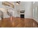 Spacious living room with fireplace, staircase, hardwood floors and tall windows, creating a bright atmosphere at 3115 Corsair Curv, Cumming, GA 30040