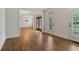 Open living space with hardwood floors and access to additional rooms and outdoor access at 3115 Corsair Curv, Cumming, GA 30040
