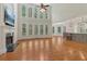 Bright living room featuring hardwood floors, tall windows, a fireplace and modern lighting at 3115 Corsair Curv, Cumming, GA 30040