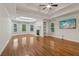 Bright living room featuring a fireplace, large windows, hardwood floors and tray ceiling at 3115 Corsair Curv, Cumming, GA 30040