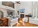 Bright living room featuring hardwood floors, tall windows, a fireplace and comfortable furniture at 3115 Corsair Curv, Cumming, GA 30040