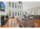 Bright living room featuring hardwood floors, tall windows, a fireplace and modern lighting at 3115 Corsair Curv, Cumming, GA 30040