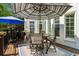 Outdoor patio shaded by umbrellas with a table and chairs and a built in barbecue grill at 3115 Corsair Curv, Cumming, GA 30040