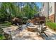 Backyard patio with outdoor seating around a fire pit, perfect for entertaining and relaxing at 3115 Corsair Curv, Cumming, GA 30040