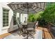 Enjoy outdoor dining on this backyard deck complete with a table, chairs, and a sun umbrella at 3115 Corsair Curv, Cumming, GA 30040