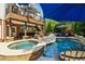 Outdoor living space with an in-ground pool, spa, lounge chairs, and a covered patio at 3115 Corsair Curv, Cumming, GA 30040