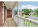 Inviting porch with a view of the neighborhood, enhanced with white railings and brick accents at 3115 Corsair Curv, Cumming, GA 30040