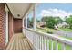 Picturesque porch with white railings offering neighborhood views and red brick exterior at 3115 Corsair Curv, Cumming, GA 30040