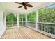Screened-in porch overlooking a lush, wooded yard at 3115 Corsair Curv, Cumming, GA 30040