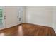 Bright room features hardwood floors and door to exterior at 3115 Corsair Curv, Cumming, GA 30040