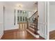 Open staircase features wood steps and decorative iron railings, enhancing the home's interior at 3115 Corsair Curv, Cumming, GA 30040