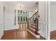 Inviting staircase with decorative iron railing and hardwood steps, open to the living area at 3115 Corsair Curv, Cumming, GA 30040