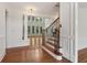 Bright staircase with wood treads and wrought iron railing, complemented by white trim and hardwood floors at 3115 Corsair Curv, Cumming, GA 30040