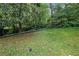 Spacious backyard with mature trees and a manicured lawn at 5618 Fern Creek Sw Dr, Lilburn, GA 30047