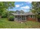 Backyard view of the screened-in porch and patio area at 5618 Fern Creek Sw Dr, Lilburn, GA 30047