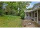 View of the backyard with patio, shrubs, and greenery at 5618 Fern Creek Sw Dr, Lilburn, GA 30047