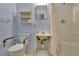 Cozy bathroom featuring blue walls, toilet with safety bars, and a shower behind a white curtain at 5618 Fern Creek Sw Dr, Lilburn, GA 30047