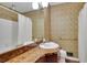 Vintage bathroom showcasing patterned wallpaper, a large mirror, and a shower-tub combo for a classic look at 5618 Fern Creek Sw Dr, Lilburn, GA 30047