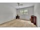 Simple bedroom features a window and ceiling fan, providing a comfortable and functional space at 5618 Fern Creek Sw Dr, Lilburn, GA 30047