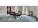Spacious dining room with blue carpet, dining table, and natural light from large windows at 5618 Fern Creek Sw Dr, Lilburn, GA 30047