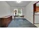 Cozy dining area featuring blue carpet, wood table, and drawers next to white walls at 5618 Fern Creek Sw Dr, Lilburn, GA 30047
