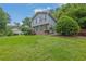 Two-story house with a lush front yard featuring brick and blue painted siding at 5618 Fern Creek Sw Dr, Lilburn, GA 30047