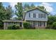 Split level home with a brick and blue facade, shuttered windows, and a well-manicured lawn at 5618 Fern Creek Sw Dr, Lilburn, GA 30047