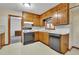 Compact kitchen with wood cabinets, black appliances, and patterned wallpaper for a cozy feel at 5618 Fern Creek Sw Dr, Lilburn, GA 30047
