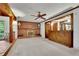 Bright living room featuring a brick fireplace, ceiling fan, and unique wood accents for a warm and inviting atmosphere at 5618 Fern Creek Sw Dr, Lilburn, GA 30047