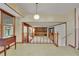 Open living space with wood accents, view of the kitchen, and staircase to lower level at 5618 Fern Creek Sw Dr, Lilburn, GA 30047