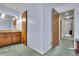 Hallway view of the main bathroom featuring wood vanity and doors, creating a practical and accessible space at 5618 Fern Creek Sw Dr, Lilburn, GA 30047