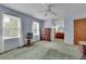 Bright main bedroom with large windows, ceiling fan, and an ensuite bathroom with a vanity at 5618 Fern Creek Sw Dr, Lilburn, GA 30047