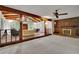 Spacious sun room with exposed beams, skylights, brick flooring, a fireplace, and a wall of windows offering natural light at 5618 Fern Creek Sw Dr, Lilburn, GA 30047