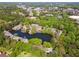 A picturesque view showcases the neighborhood's pond and surrounding lush greenery and landscaping at 103 Mill Pond Rd, Roswell, GA 30076