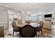 Open-concept dining room with modern lighting and seamless flow into the kitchen and living areas at 103 Mill Pond Rd, Roswell, GA 30076