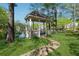 Charming lakeside gazebo surrounded by lush greenery offers a serene retreat at 103 Mill Pond Rd, Roswell, GA 30076