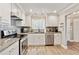 Bright kitchen featuring white cabinets, granite countertops, and stainless steel appliances at 103 Mill Pond Rd, Roswell, GA 30076