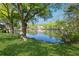 Scenic view of the lake surrounded by mature trees and landscaped grounds at 103 Mill Pond Rd, Roswell, GA 30076
