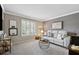Cozy living room with neutral walls, plantation shutters, and comfortable furnishings at 103 Mill Pond Rd, Roswell, GA 30076