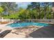 Outdoor pool area with plenty of lounge chairs and tables for community enjoyment at 103 Mill Pond Rd, Roswell, GA 30076