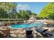 Community pool area with lounge chairs, tables, and a gazebo, perfect for outdoor fun at 103 Mill Pond Rd, Roswell, GA 30076