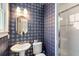Stylish bathroom showcasing unique wallpaper and a modern vanity with glass shower at 1256 Spring Valley Ne Ln, Atlanta, GA 30306