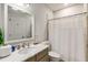 Bathroom featuring a large vanity, modern mirror, commode, and shower with curtain at 1256 Spring Valley Ne Ln, Atlanta, GA 30306