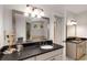 Bathroom featuring dual vanities, a large mirror, and modern lighting at 1256 Spring Valley Ne Ln, Atlanta, GA 30306