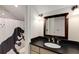 Modern bathroom with black countertop and a fun dinosaur-themed shower curtain at 1256 Spring Valley Ne Ln, Atlanta, GA 30306