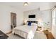 Bright bedroom with ensuite bathroom, hardwood floors, and natural light from large windows at 1256 Spring Valley Ne Ln, Atlanta, GA 30306