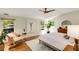 This bright bedroom has hardwood floors, and neutral tones, with a ceiling fan at 1256 Spring Valley Ne Ln, Atlanta, GA 30306