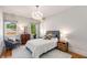 This cozy bedroom features a plush bed, a comfortable chair, and natural light from the windows at 1256 Spring Valley Ne Ln, Atlanta, GA 30306