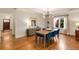 Bright dining area with wood floors, stylish light fixture, and view of the entry at 1256 Spring Valley Ne Ln, Atlanta, GA 30306